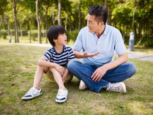 asian father and son having a conversation