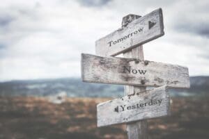 Tomorrow, now, yesterday signpost in nature. Future, present, past concept.